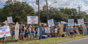 Central Surfers Protest on Hooper Road, Tell Wade Evans He Can’t Leave Until The Lake is Done